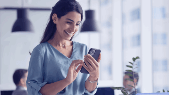 A woman uses a phone.